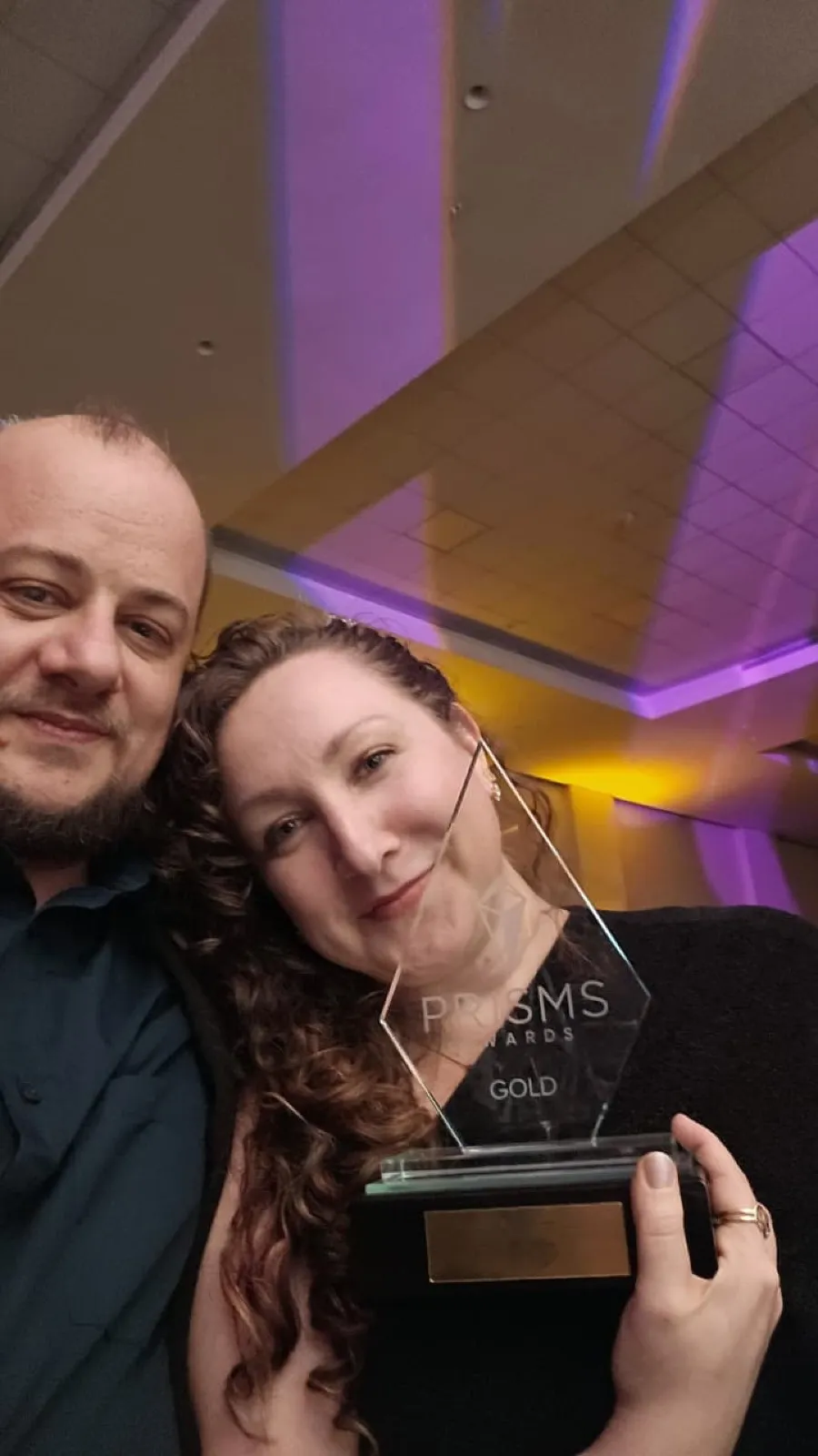 Tracy Margetts celebrating her PRISMS 2026 Gold Award with MC Sonnekus